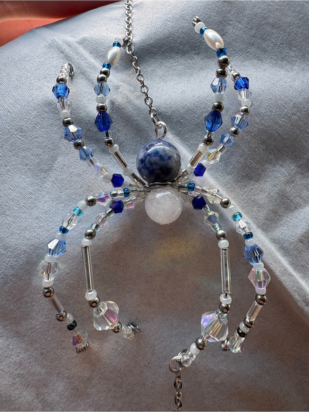 Handcrafted upcycled Blue & White Beaded Spider sun catcher. Made with sodalite